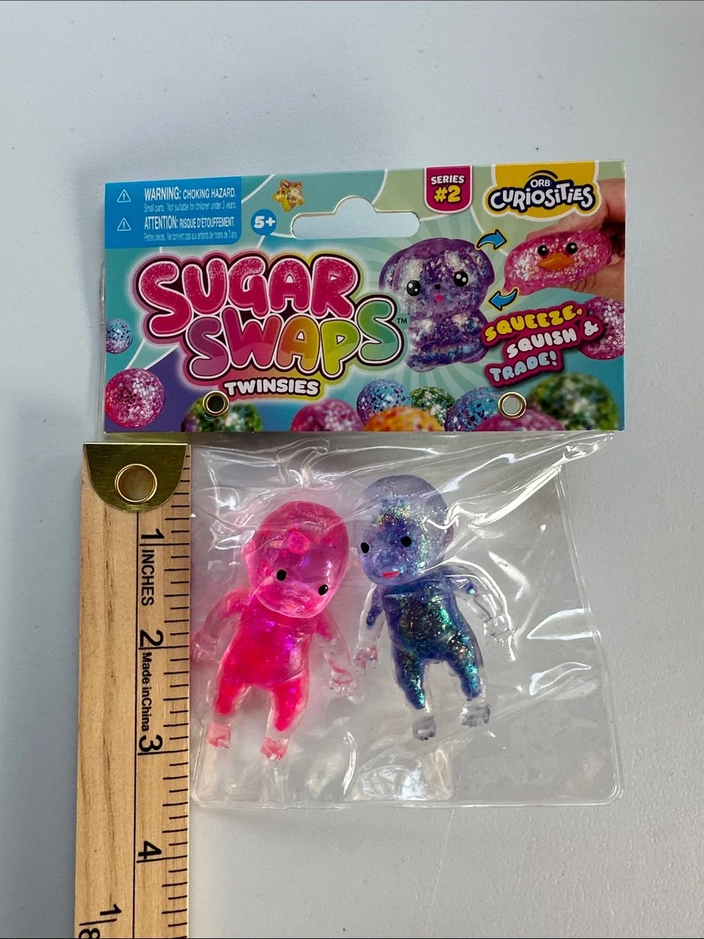 Sugar Swaps TWINSIES - Pink & Purple Glitter Squishy Squeeze Baby Figures, Orb